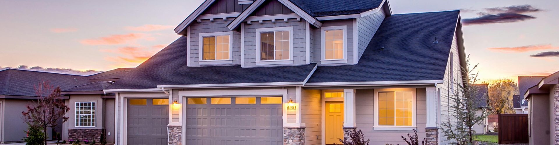 Elegant suburban home with driveway at sunset showcasing modern architecture.